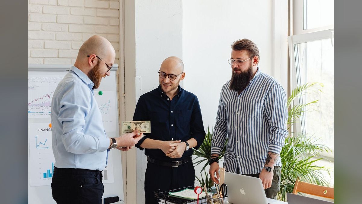 How do you compensate a sales manager whose reps overperform — pay them on team total or on personal stretch goals?