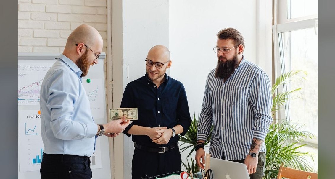 How do you compensate a sales manager whose reps overperform — pay them on team total or on personal stretch goals?